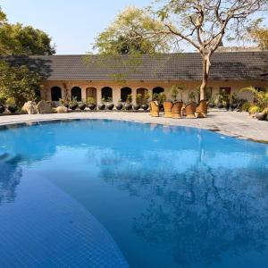 a large blue swimming pool in front of a building at Shannu's Ranch Inn in Pushkar