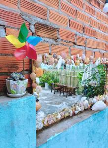 a patio with a bunch of shells and umbrellas at Bot Bien Homestay in Mui Ne
