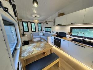 a kitchen and living room of a tiny house at Tiny House Scarlet in Dziemiany