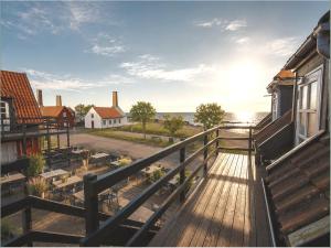 a balcony of a house with a view of the ocean at Klippen Hotel - Skt Jørgens Gaard in Gudhjem
