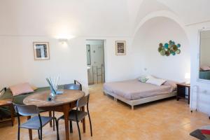 a room with a table and a bed and a bedroom at Il Mulino di Scauri in Pantelleria