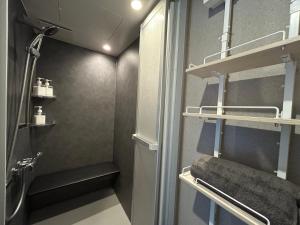 a small bathroom with a shower and a sink at Villa ORAN in Nakafurano +33 photos