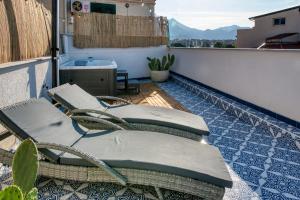 a balcony with two chairs and a sink on a building at Zisa Top Romantic Terrace & Private outdoor Jacuzzi in Palermo