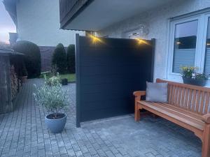a wooden bench sitting in front of a house with lights at La Casa in Medebach +6 photos