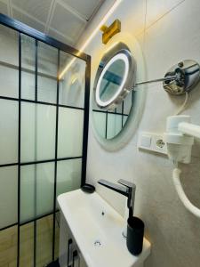 a bathroom with a sink and a mirror on the wall at Kasr-ı Cihan Boutique Hotel in Midyat