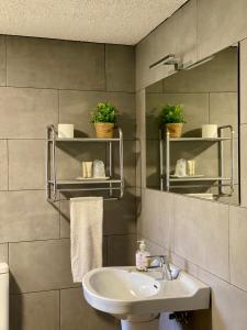a bathroom with a sink and a mirror at Hostal Moliné in Bruguera