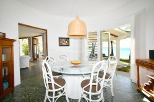 a dining room with a glass table and chairs at Villa Eva in Belle Mare