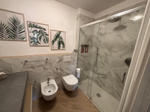 a bathroom with a shower and a toilet and a sink at Vicolo dell'Orto in Montaione +18 photos