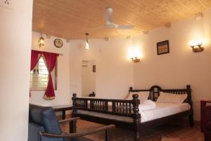 a bedroom with a bed and a ceiling fan at The Royal Valley Resort in Chotila