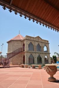 a large brick building with a staircase in front of it at The Royal Valley Resort in Chotila