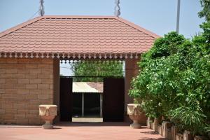 a red brick building with an open door at The Royal Valley Resort in Chotila