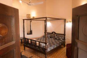 a bedroom with a canopy bed in a room at The Royal Valley Resort in Chotila