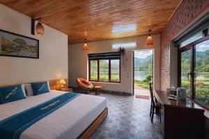 a bedroom with a bed and a desk and a window at Chinh Thu Garden Homestay in Ninh Binh