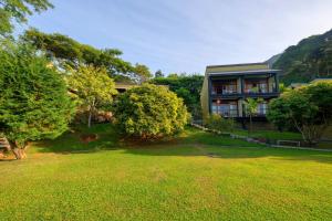 a house with a large yard in front of it at Melheim Resort & Spa Haputale - An Infinite Escape into the Paradise in Haputale +90 photos
