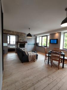 a living room with a couch and a table at Turu 6, Quiet Central Apartment in Haapsalu