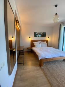 a bedroom with a bed and a table in it at Stone Apartment with sauna Sinaia in Sinaia