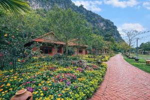 a brick path leading to a garden with flowers at Chinh Thu Garden Homestay in Ninh Binh