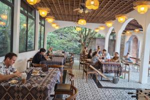 a group of people sitting at tables in a restaurant at Chinh Thu Garden Homestay in Ninh Binh