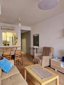 a living room with a couch and a table at 2 Duplex Las Terrazas Cubes in Vélez de Benaudalla