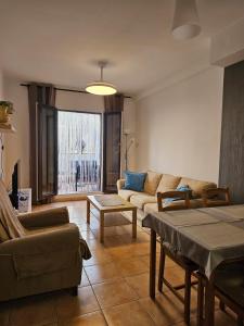 a living room with a couch and a table at 2 Duplex Las Terrazas Cubes in Vélez de Benaudalla