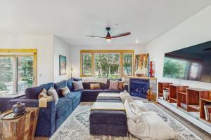 a living room with a blue couch and a fireplace at Moose Crossing at Town Center in Big Sky