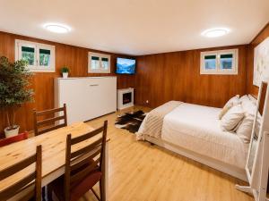 a bedroom with a bed and a table and a television at The Swiss Paradise 3 Cozy Mountain Studio in Wirzweli