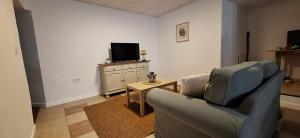 a living room with a couch and a tv at Casa Ameghino in Laujar de Andarax