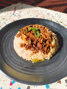 a plate of rice and meat on a table at EcoGlampLife in Kalgha