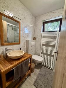 a bathroom with a sink and a toilet at Elton384 in Bogojina