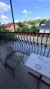 a table and chair on a balcony with a view at Стара Прага in Uzhhorod