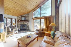 a living room with a couch and a fireplace at Woodlands 34 in Mammoth Lakes