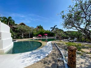 a swimming pool at a house with a resort at Sea view apartments in Nathon Bay