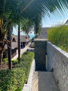 a view of a resort with palm trees and a walkway at Sea view apartments in Nathon Bay