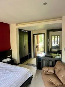 a bedroom with a bed and a couch in it at Sea view apartments in Nathon Bay