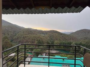 a balcony with a view of a swimming pool at new vintage penthouse in Bhowāli