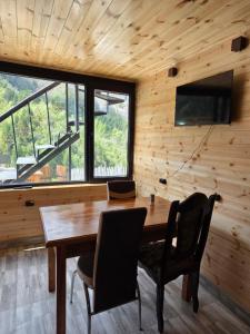a dining room with a wooden table and chairs at Vista Adishi in Adishi