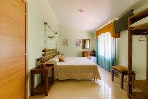 a bedroom with a bed in a room at Oasi Scolacium in Villaggio Le Rocelle +35 photos