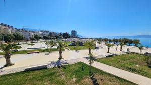 a view of a park with palm trees and the ocean at Apartments Deja Views - Žnjan beach in Split