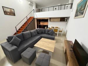a living room with a couch and a table at Sea Gate Apartments in Sarandë