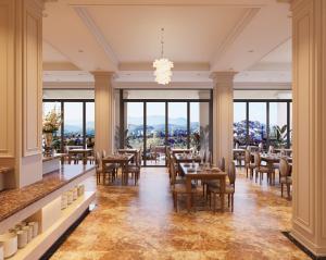 a restaurant with tables and chairs and large windows at Dalabiang Hotel in Da Lat