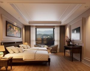 a bedroom with a bed and a desk and a window at Dalabiang Hotel in Da Lat +58 photos