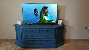 a tv sitting on top of a blue dresser at Colle Costanza in Todi