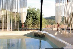 a swimming pool in a house with curtains on the window at Thassion-ikea Feels Like Home in Astris