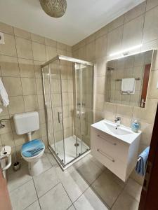 a bathroom with a shower and a toilet and a sink at Apartment Smuljic in Vrboska +25 photos