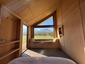 a room with a large window with a view of a mountain at Ben Nevis Basecamp in Torlundy