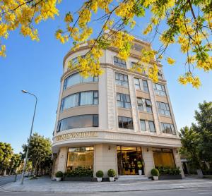 a building with a store in front of it at The Manor Hotel in Nam Ðịnh