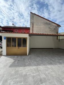 a building with a garage with a red roof at Cantalupo 3 in Cantalupo