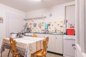 a kitchen with a table and two chairs at Appartement ambiance vieux chalet in Sembrancher