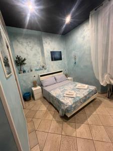 a bedroom with a bed with two towels on it at Il Corallo in Terracina