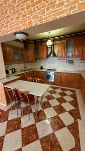 a kitchen with a table and chairs in a room at Стара Прага in Uzhhorod